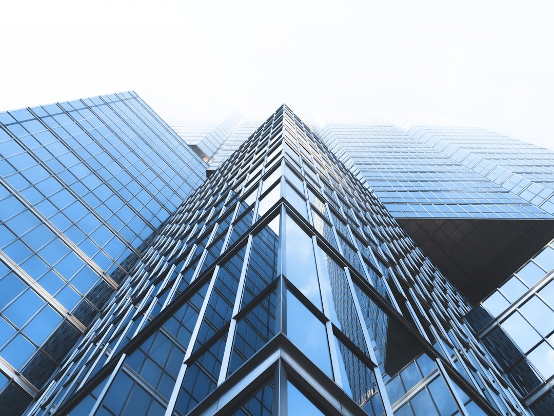 Commercial office building with geometric glass facade - representing building systems and HVAC infrastructure